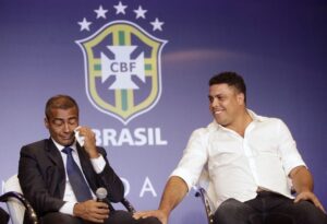 Brazil congressman Romario reacts while being consoled by World Cup's local organizing committee member Ronaldo in Rio de Janeiro