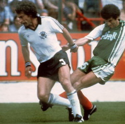 West German defender Paul Breitner (R) tries to co